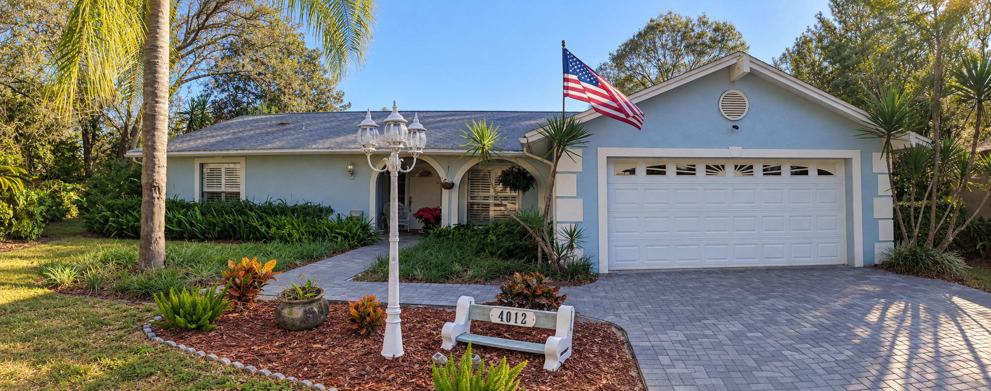 Before: a pale blue Tampa Bay home with a white garage door